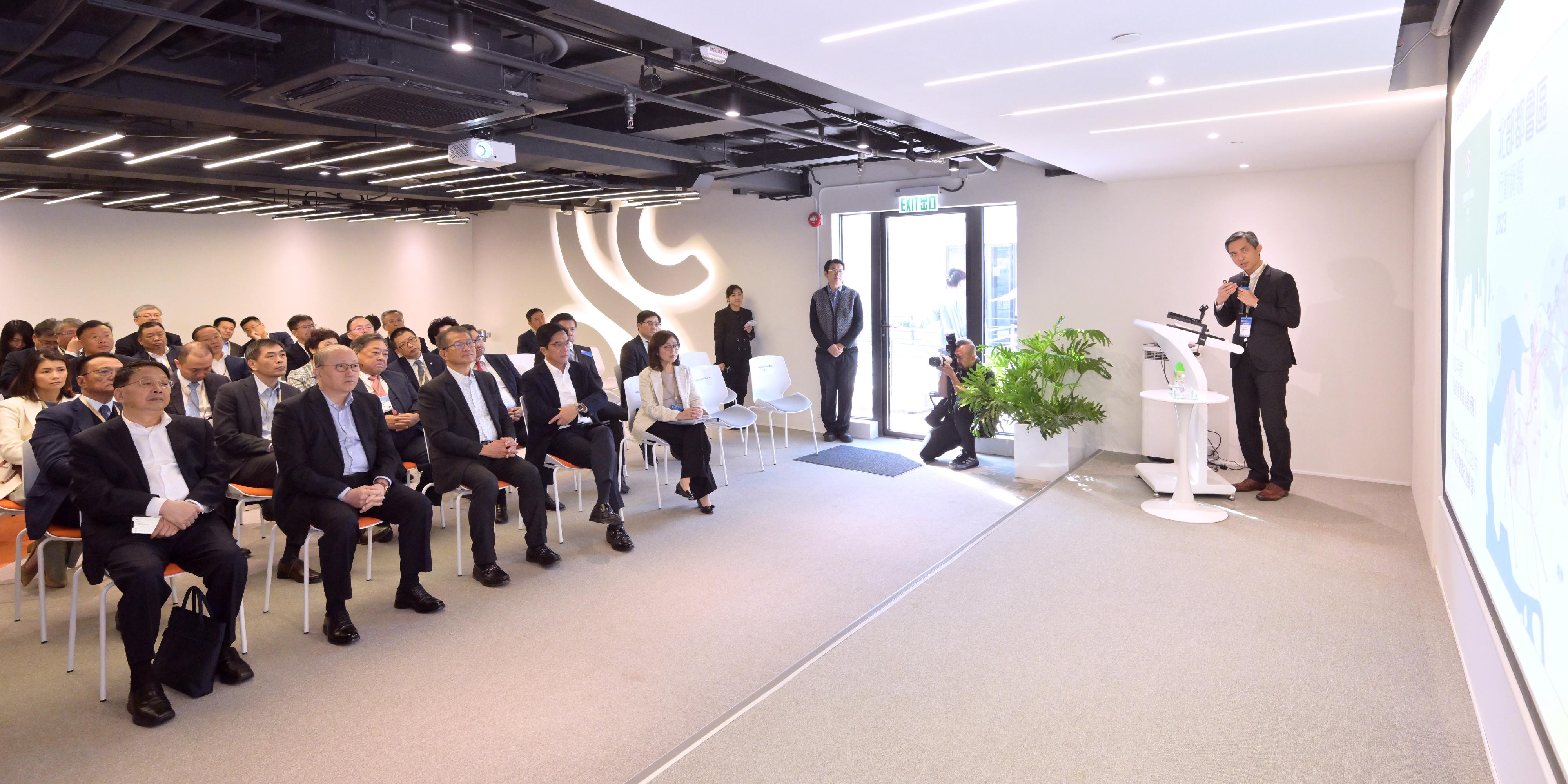 The Financial Secretary, Mr Paul Chan, led a delegation of enterprise representatives to visit the Northern Metropolis (NM) today (November 29). Photo shows the Director of the Liaison Office of the Central People's Government in the Hong Kong Special Administrative Region, Mr Zheng Yanxiong (first row, second left), Mr Chan (first row, third left), other officials and representatives of enterprises being briefed by the Director of the Northern Metropolis Co-ordination Office, Mr Vic Yau (first right), on the overall planning and latest development of the NM, during a visit to "the Loop" of the Civil Engineering and Development Department in the Loop.